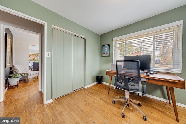 office featuring light wood-type flooring and baseboards