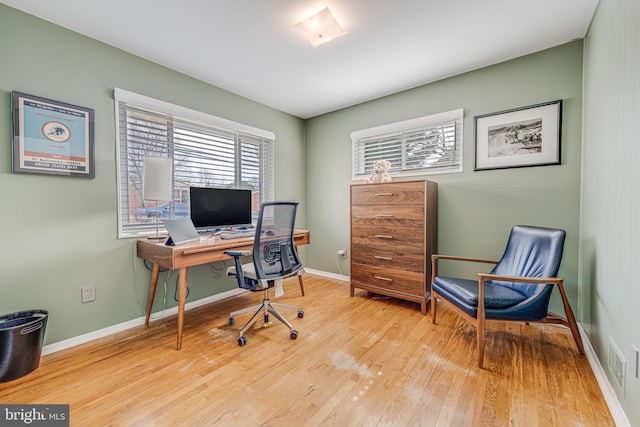 office space featuring baseboards and wood finished floors