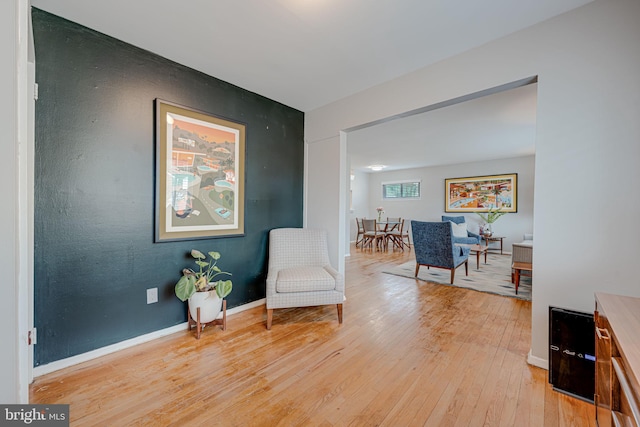 sitting room featuring light wood-style flooring and baseboards