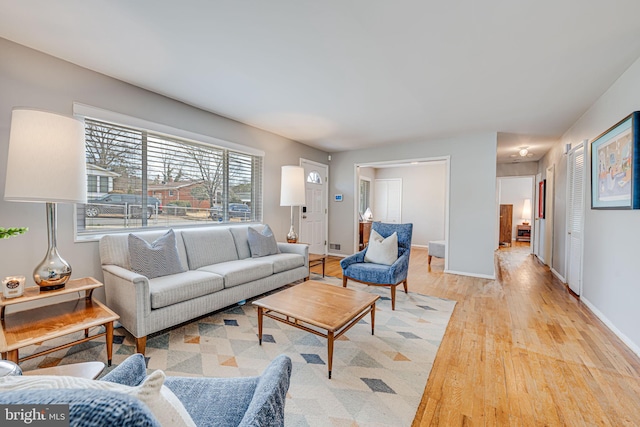 living room with light wood finished floors and baseboards