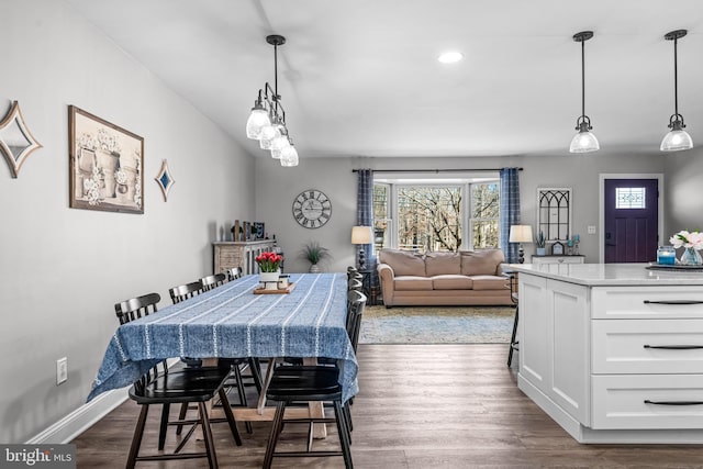 dining space featuring recessed lighting, dark wood finished floors, and baseboards