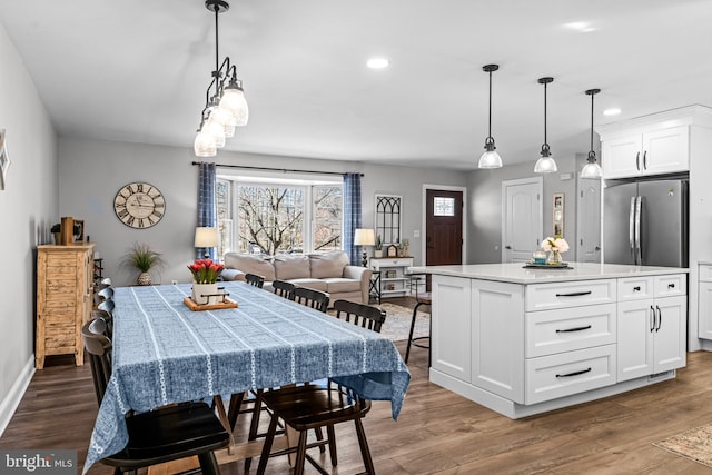 dining space with recessed lighting, baseboards, and wood finished floors