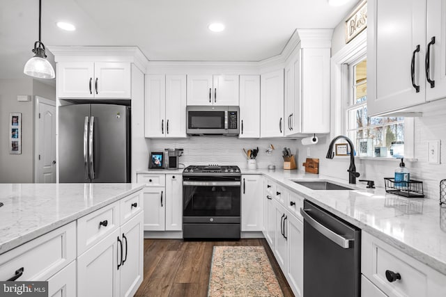 kitchen featuring stainless steel appliances, dark wood finished floors, white cabinets, and a sink