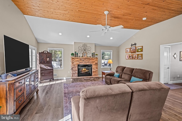 living room featuring lofted ceiling, a stone fireplace, dark wood-style flooring, and wood ceiling