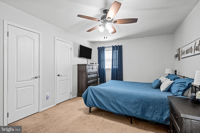 bedroom with ceiling fan and light colored carpet