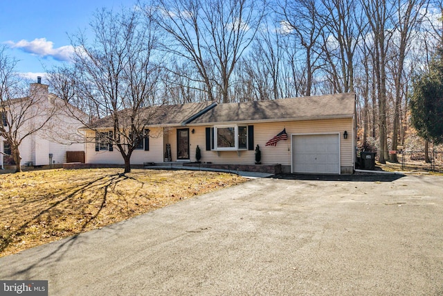 single story home with a garage, driveway, and fence