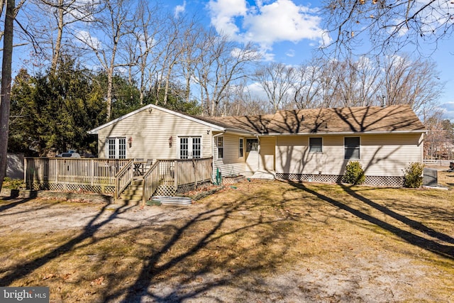 view of front of home featuring a front yard and a deck