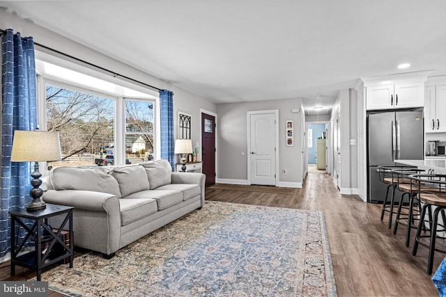 living area with wood finished floors and baseboards