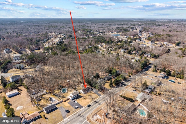 bird's eye view featuring a wooded view