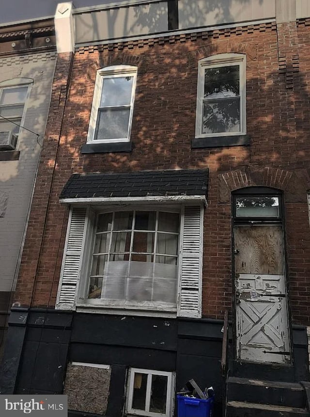 view of side of property with brick siding