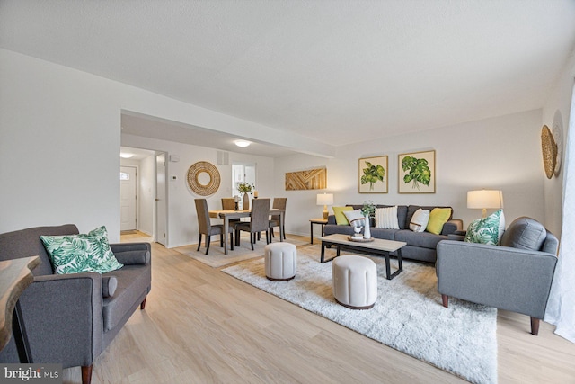 living area featuring light wood-type flooring and baseboards