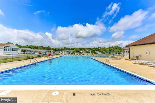 pool featuring a patio and fence