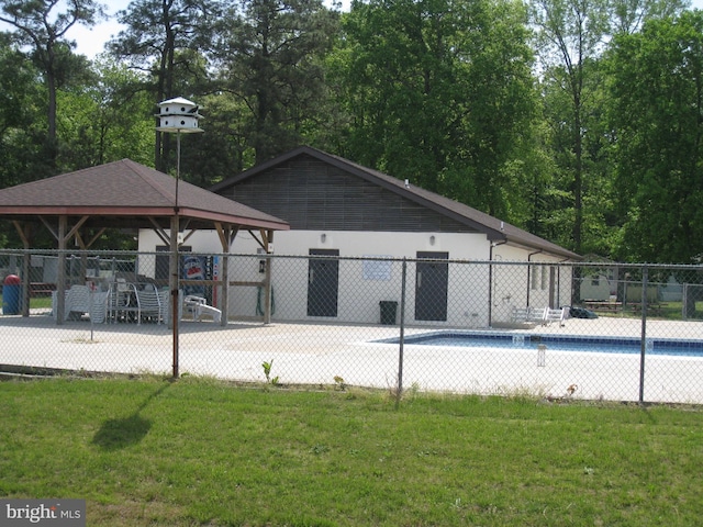 community pool featuring fence, a lawn, and a gazebo