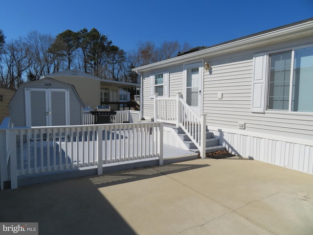 exterior space featuring a patio area, a storage unit, and an outbuilding