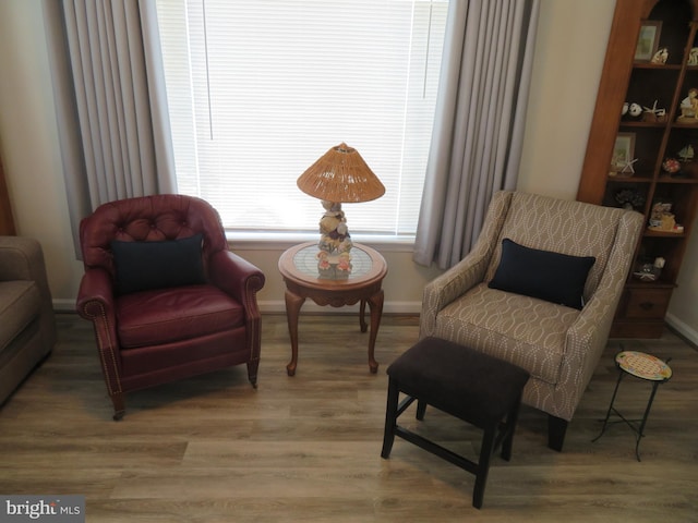 living area with wood finished floors and baseboards