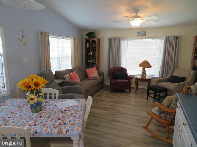 living room with vaulted ceiling, wood finished floors, and a ceiling fan