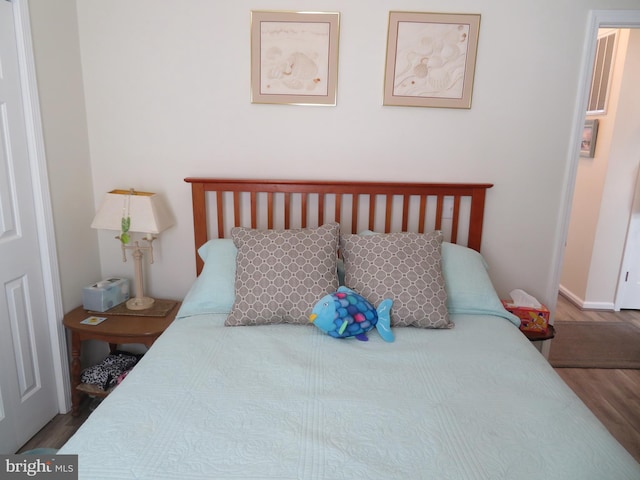 bedroom featuring wood finished floors