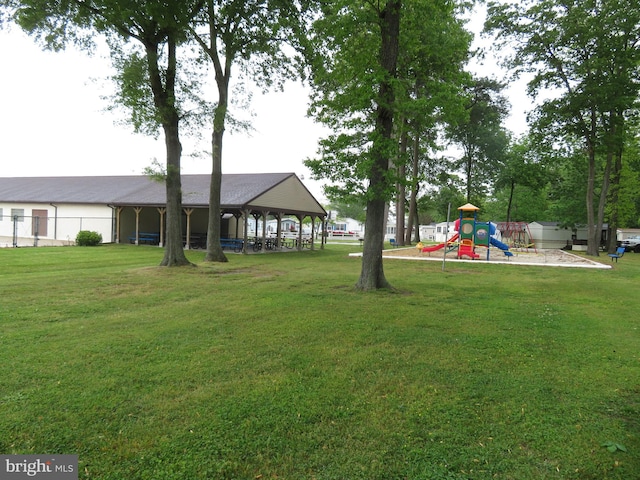 view of yard featuring fence and playground community