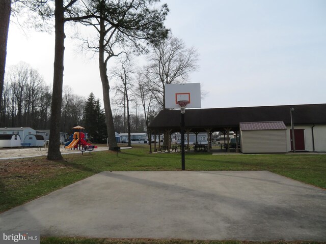 view of basketball court featuring community basketball court, playground community, and a yard