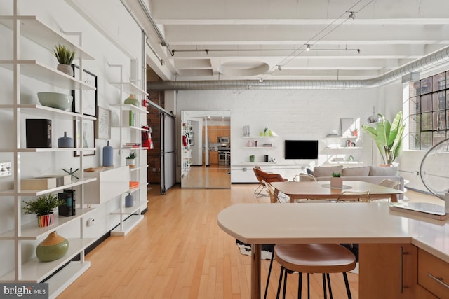 kitchen with light wood-type flooring and stainless steel oven