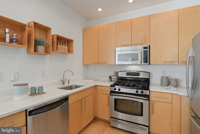 kitchen featuring stainless steel appliances, open shelves, a sink, and light countertops