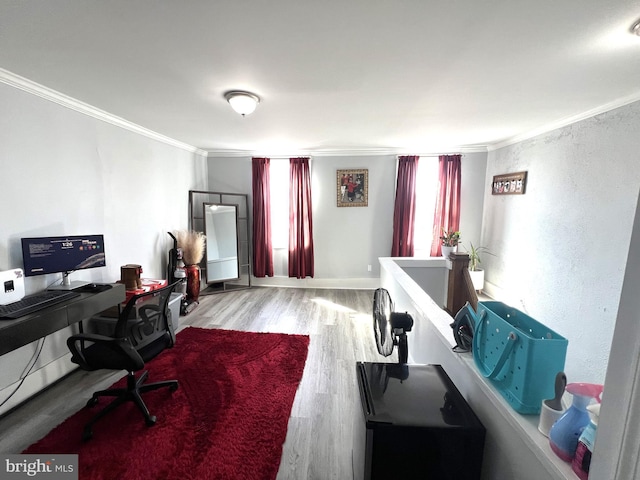 office area featuring crown molding, baseboards, and wood finished floors