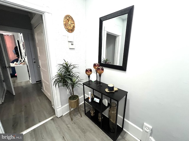 hallway with baseboards and wood finished floors