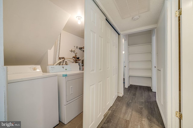 laundry area featuring laundry area, visible vents, dark wood-style flooring, and washer and dryer