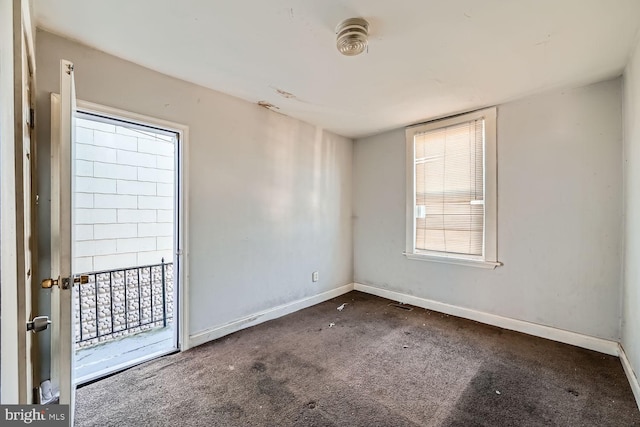 unfurnished room with carpet flooring, visible vents, and baseboards