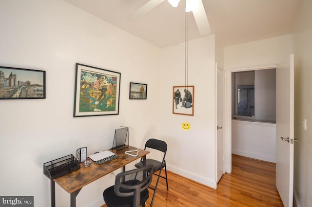 office with light wood-type flooring, ceiling fan, and baseboards