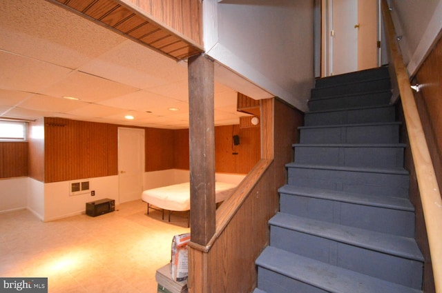 stairway with a paneled ceiling, recessed lighting, visible vents, and tile patterned floors