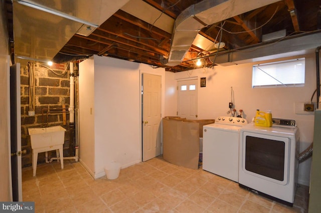 laundry area featuring a sink, laundry area, and washing machine and dryer