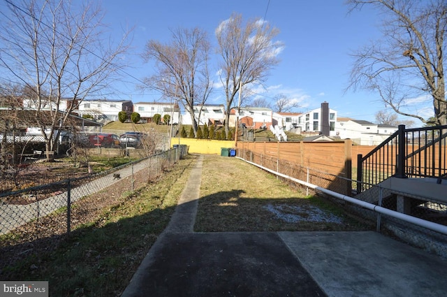 view of yard featuring a residential view and fence