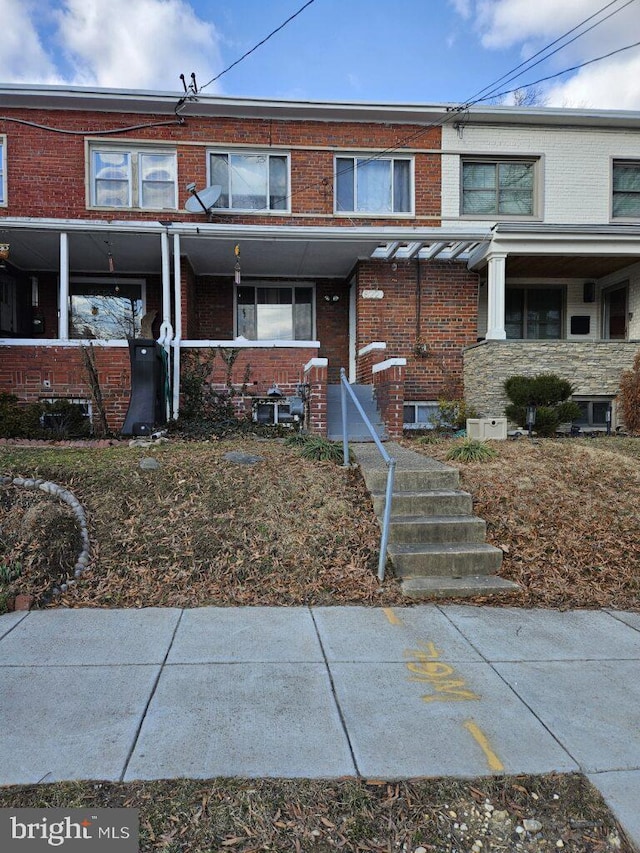 townhome / multi-family property with brick siding