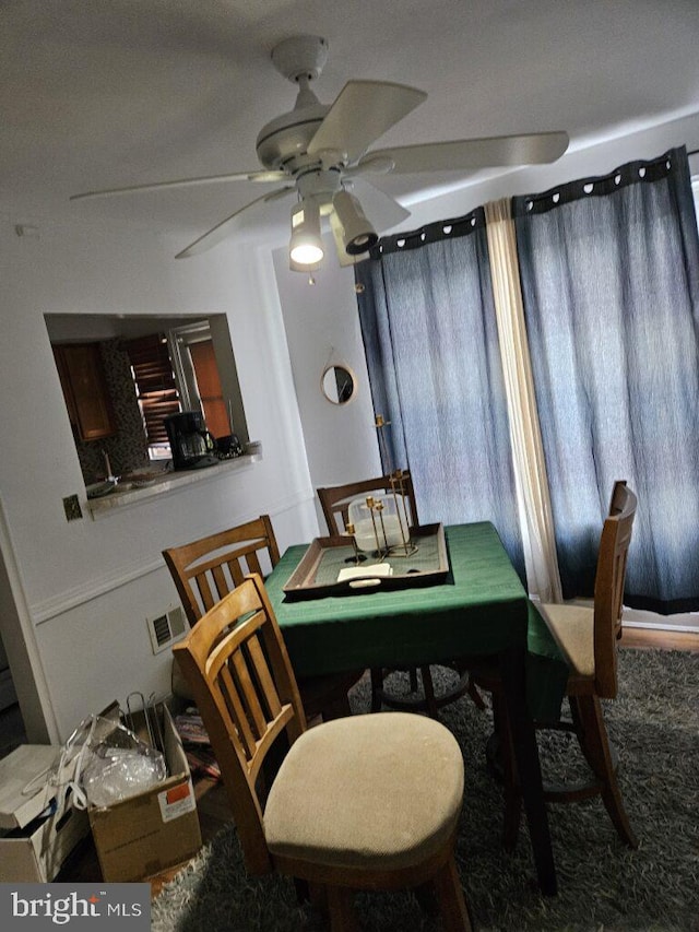 dining room with ceiling fan and visible vents