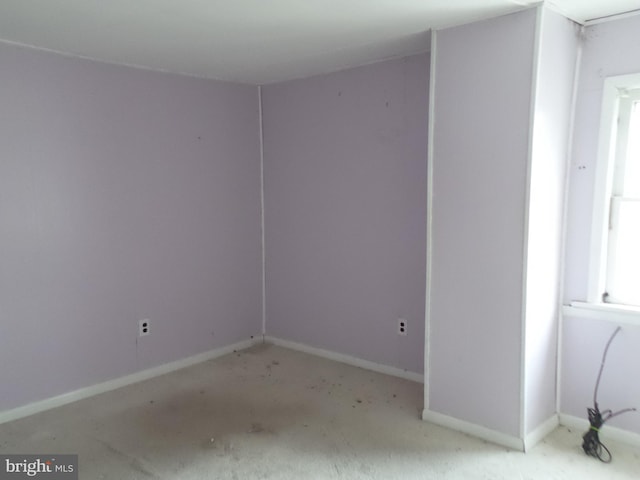 spare room featuring baseboards