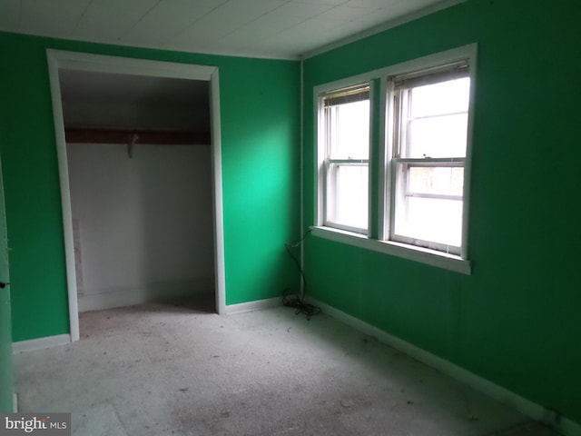 unfurnished bedroom featuring a closet and baseboards