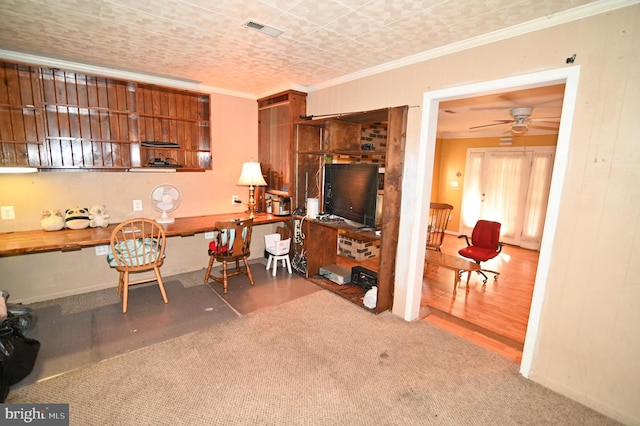 office with a ceiling fan, visible vents, crown molding, and carpet flooring