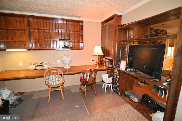 home office with built in desk and crown molding