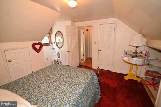 bedroom featuring lofted ceiling and baseboards