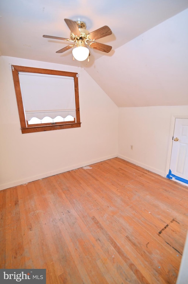 bonus room with a ceiling fan, lofted ceiling, baseboards, and hardwood / wood-style flooring