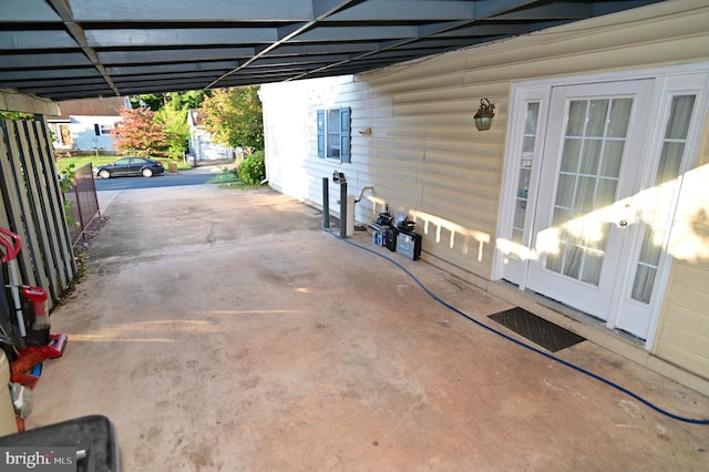 view of patio with fence and a carport