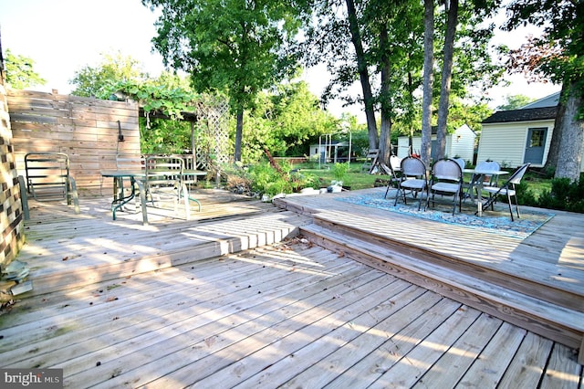 wooden deck featuring outdoor dining area