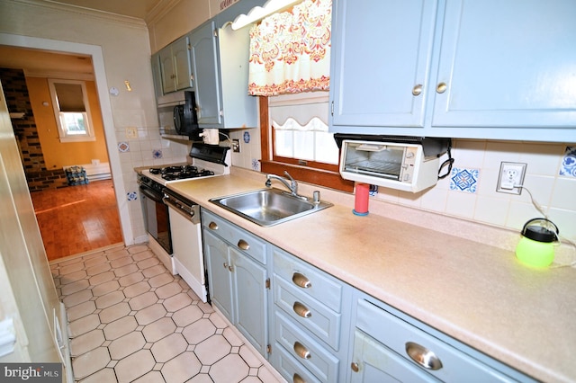 kitchen featuring range with gas cooktop, backsplash, ornamental molding, white dishwasher, and a sink