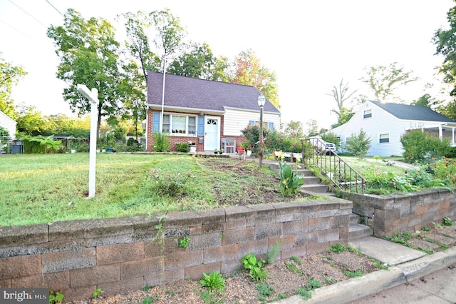 view of front facade with a front lawn and brick siding