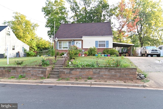 view of front of house with a carport, brick siding, and driveway