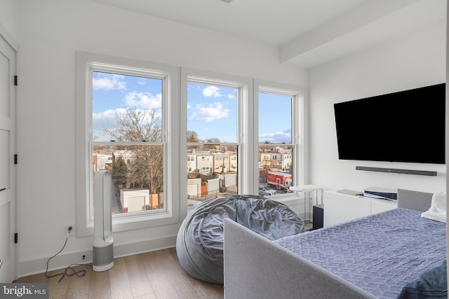 bedroom featuring wood finished floors and baseboards