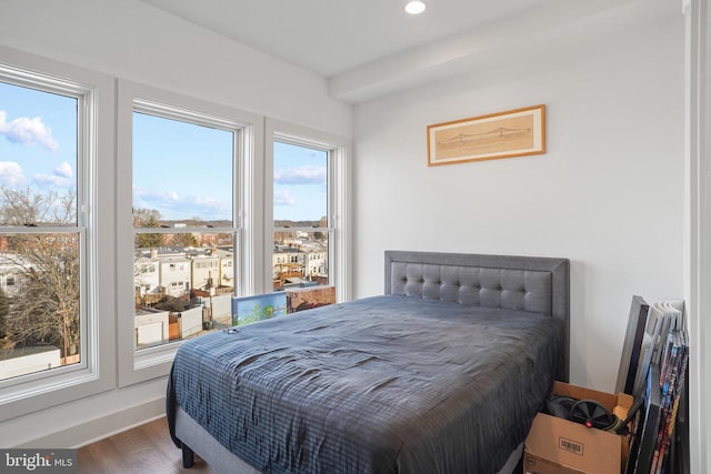 bedroom featuring baseboards, wood finished floors, and recessed lighting