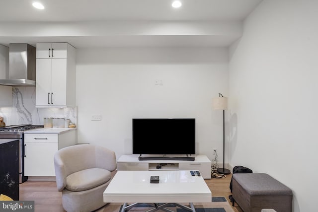 living room featuring light wood-style flooring and recessed lighting