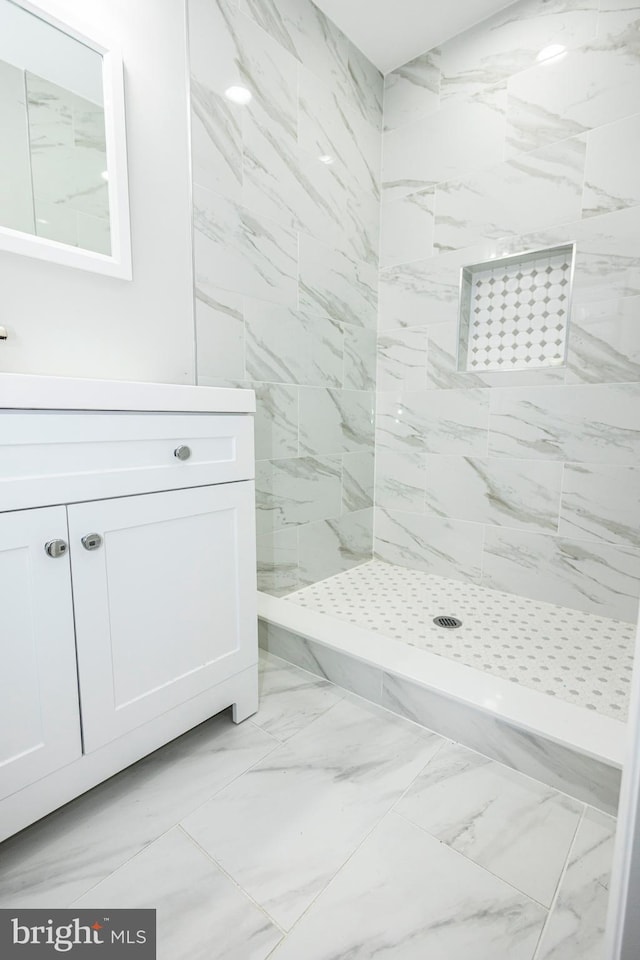 916 Phillip Powers Dr, Laurel, MD 20707 - bathroom featuring marble finish floor, a tile shower, and vanity